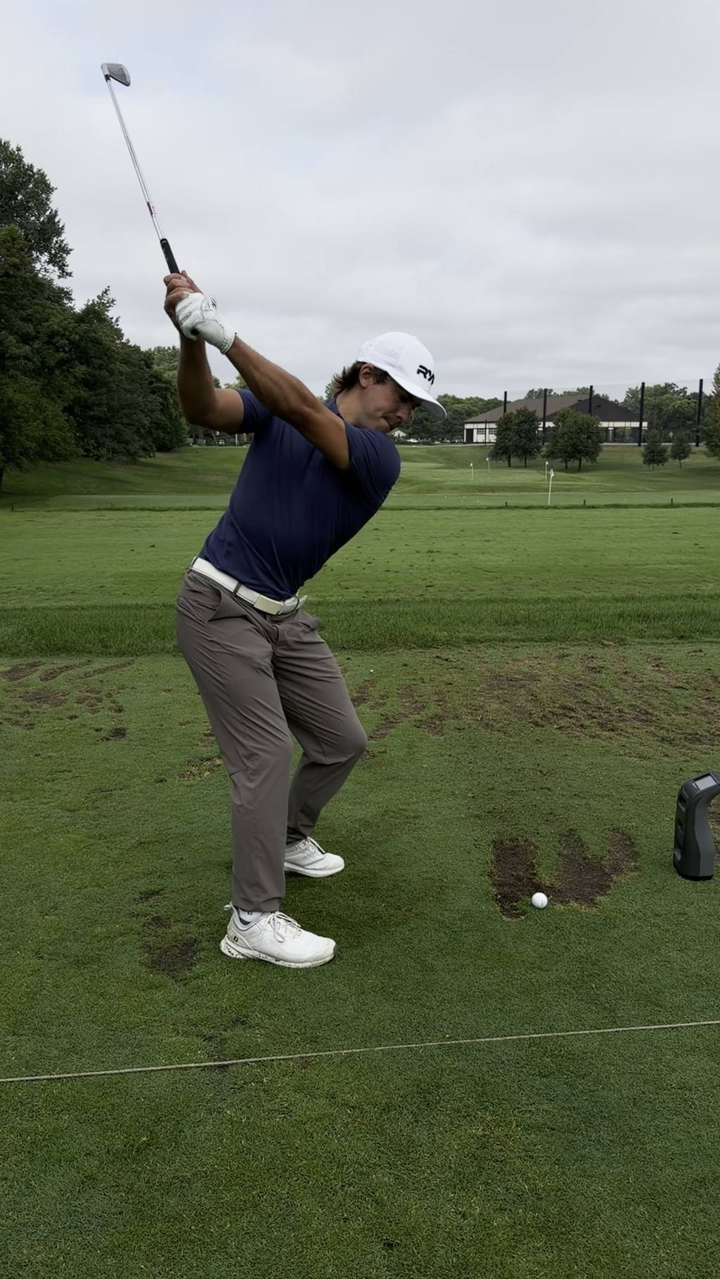A RYP Academy player at the top of the backswing on the range